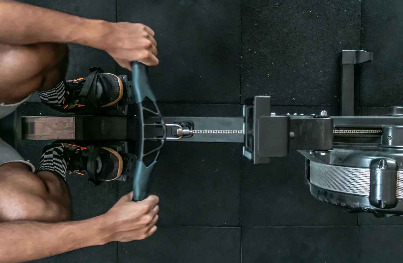 An athlete rowing during coached HYROX training at Test Gym